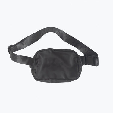 The image displays a black crossbody fanny pack with the "Tater" brand prominently embossed on the front. The strap bears a repeated slogan or message that appears to be part of the brand's design, enhancing the product's athletic appeal. The bag's compact size suggests functionality and convenience for carrying essentials, catering to an active lifestyle.