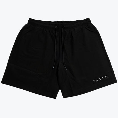 The image displays a pair of black athletic workout shorts that feature a white "TATER" logo on the left leg. These shorts are likely designed for comfort and performance, suitable for baseball practice or general athletic activities. The shorts seem to have a drawstring for adjustable fit and might be compression lined, offering additional support and mobility for athletes. The black color is classic, making them versatile for pairing with other athletic wear.