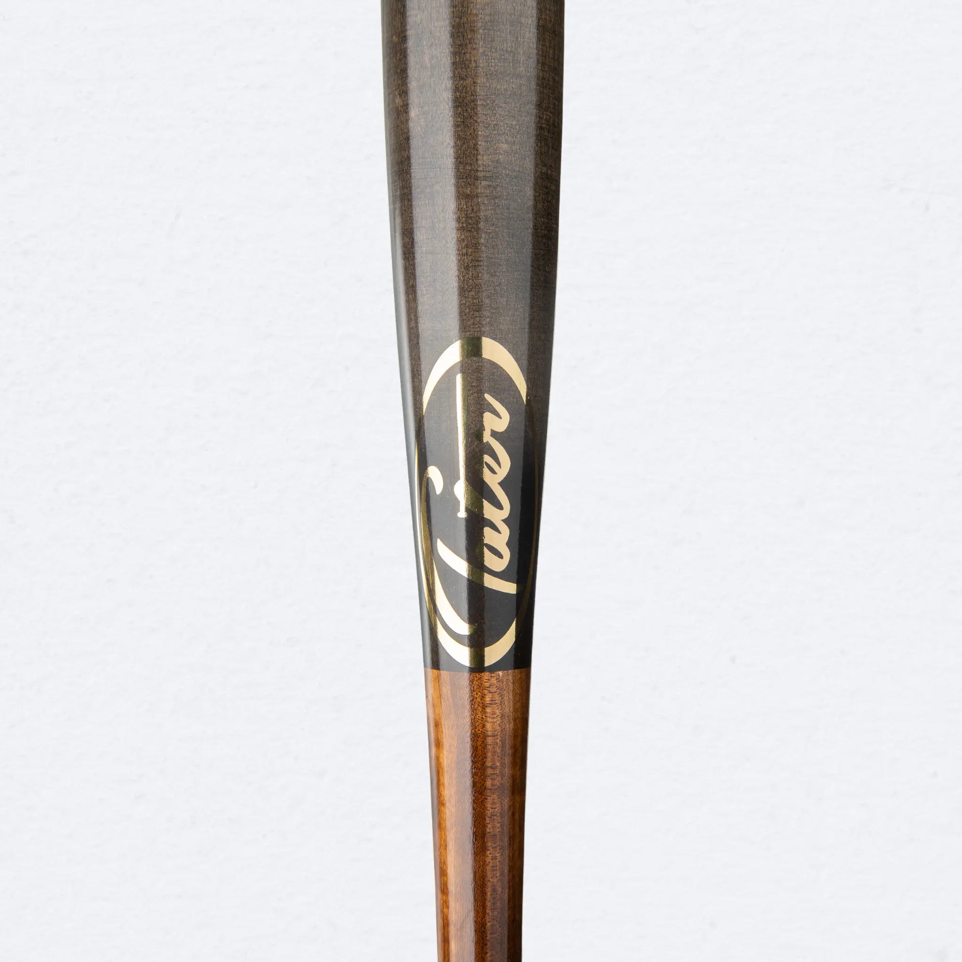 Close-up of Tater Baseball's high-quality maple wood bat, showcasing the brand logo and sleek wood grain finish.