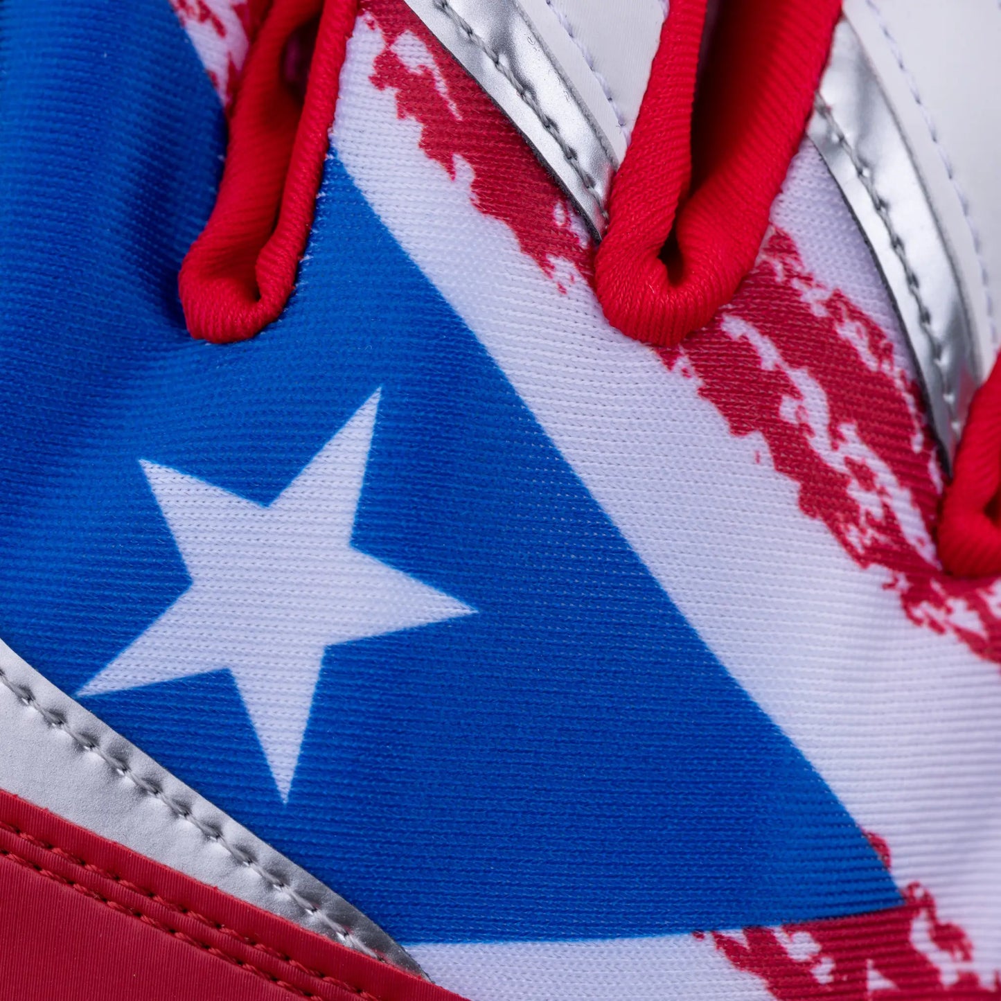 Macro detail showcasing the star of the Puerto Rican flag on Tater Baseball batting gloves, highlighted by the rich blue background and red pattern, capturing the essence of the flag's design.