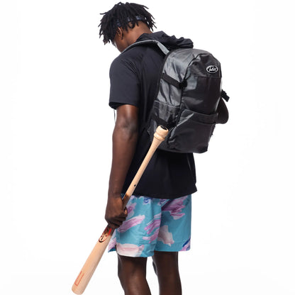 In the photo, an athlete is ready for action with a Tater Baseball backpack and a bat, wearing a black hoodie and eye-catching blue and pink workout shorts. This gear represents Tater Baseball's blend of style and functionality for the sport.