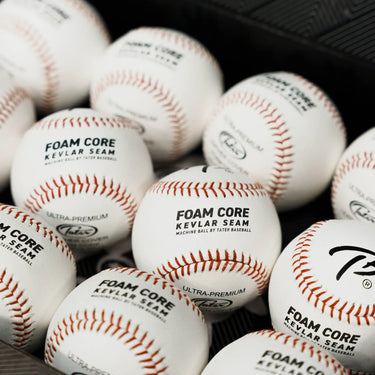 Multiple Tater Foam Core Kevlar Seam machine balls neatly packed in a black case, highlighting leather texture and high-performance design