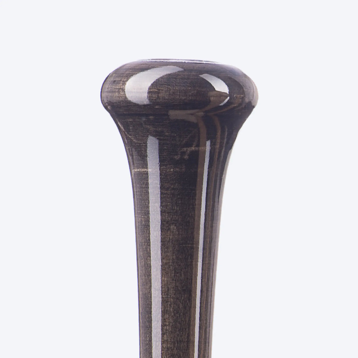 The image provides a detailed view of the top of a flared knob on a Tater wood baseball bat, showcasing the dark stained finish and the fine craftsmanship of the smooth curves and edges, characteristic of a high-quality, professional-grade bat.